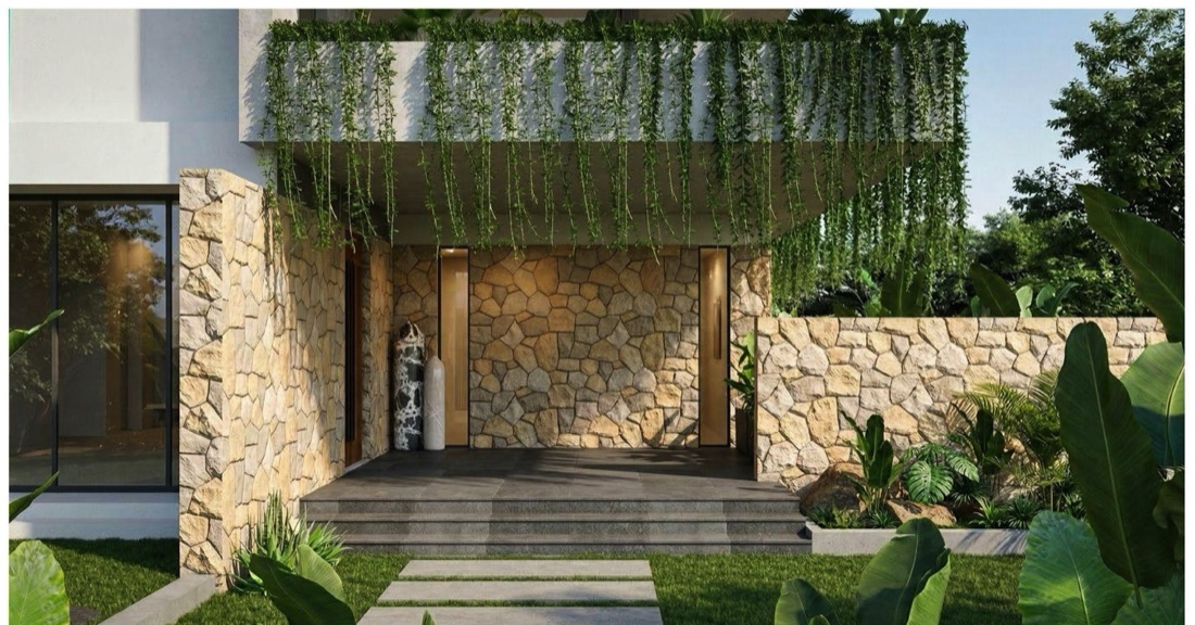Vann Esthana model villa — stone-clad entrance with hanging garden